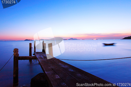 Image of Sunset at dusk along a wooden pier