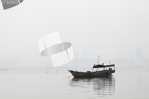 Image of Lonely boat on the sea in black and white toned