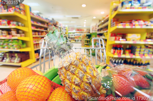 Image of Moving shopping cart in supermarket. It was taken with a slow sh