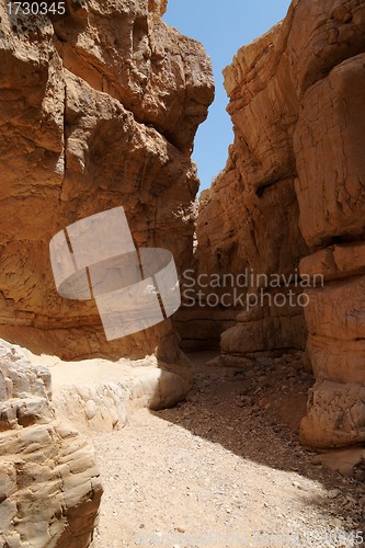 Image of Narrow slot between two rocks in desert canyon