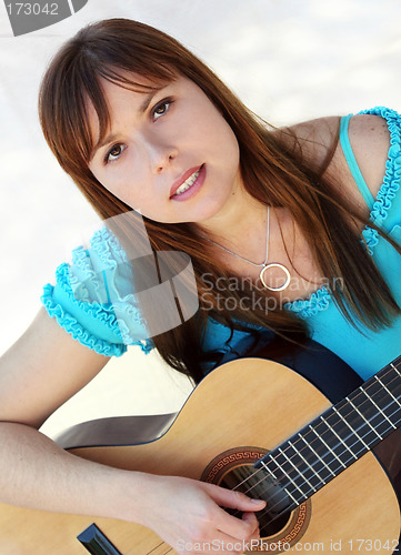 Image of Woman playing guitar