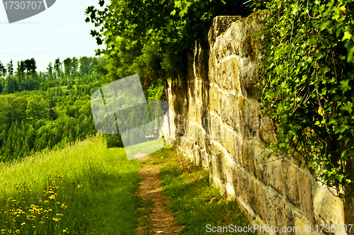 Image of park bench at an old antique abbey wall