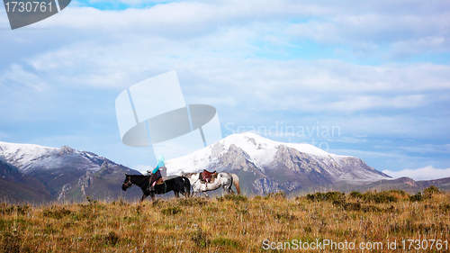 Image of Snow-capped mountains with a rider on the horseback