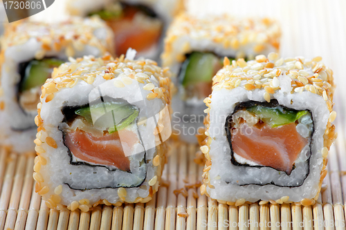 Image of sushi with salmon and cucumber