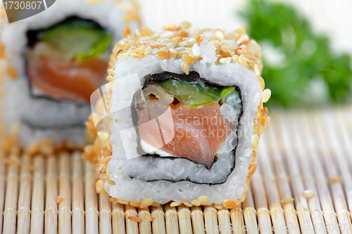 Image of sushi with salmon and cucumber