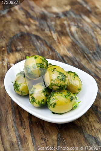 Image of green olives with fresh bread and herbs