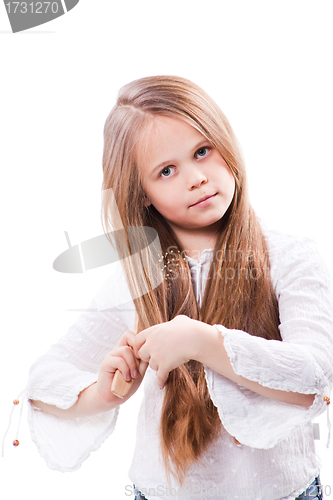 Image of Cute girl combing fine long blond hair on isolated white