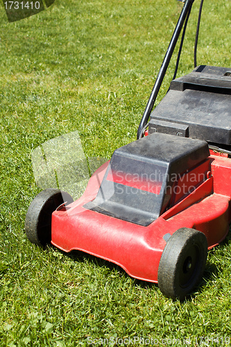 Image of lawnmower on green grass