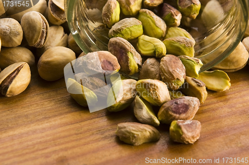 Image of Roasted pistachios on natural wooden table