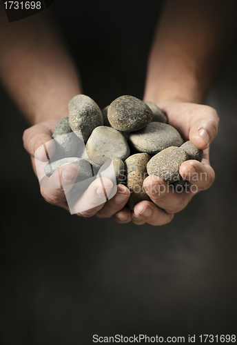 Image of Hands full of rocks