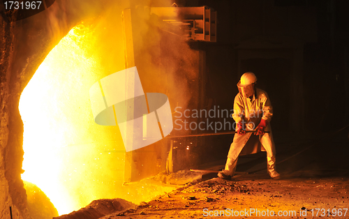 Image of worker takes a sample at steel company 