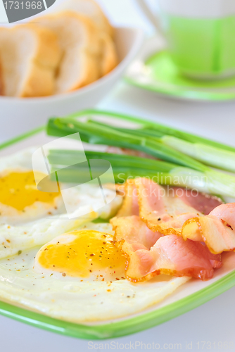 Image of breakfast with bacon and fried eggs