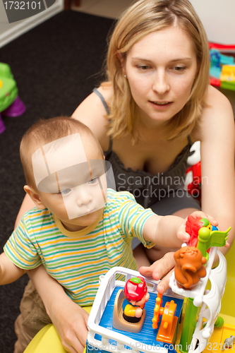 Image of Baby And Mother Playing With The Toys