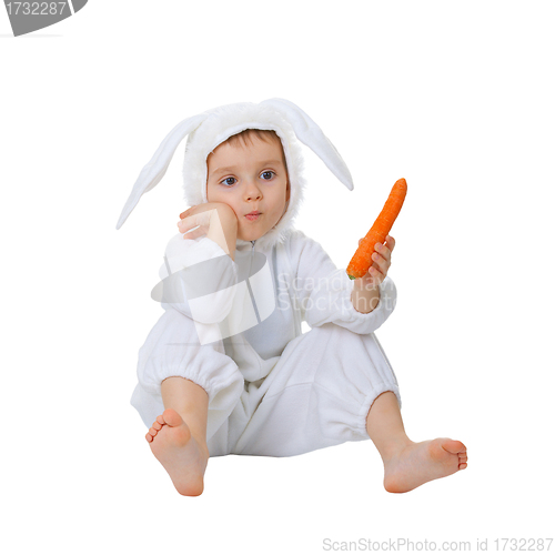 Image of Child dressed as a rabbit with a carrot