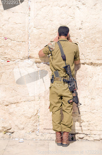 Image of Israel military man praying The Western Wall Jerusalem Palestine