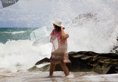 Image of The lady in the white hat is the wave on the beach