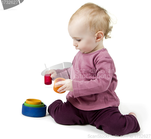 Image of young child playing with colorful toy blocks