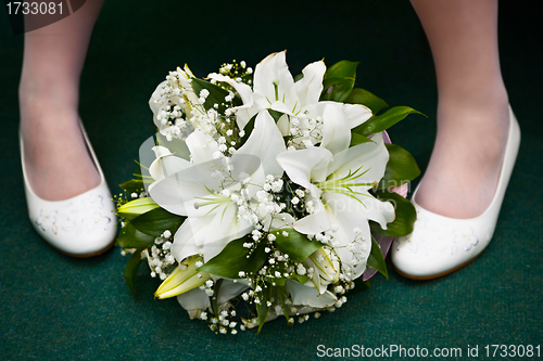 Image of Bridal bouquet and bride's feet