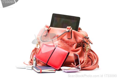 Image of Pink Leather Ladies Handbag with Tablet PC on white background 