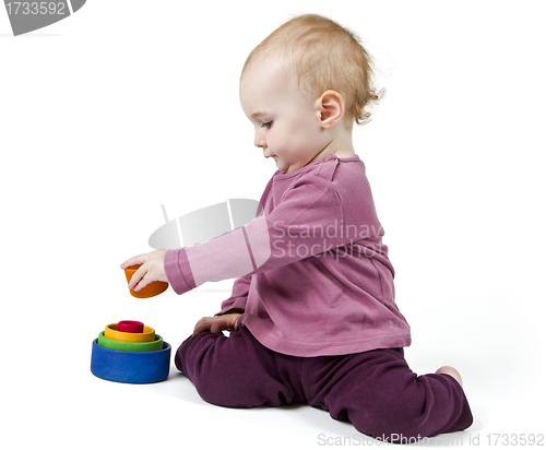 Image of young child playing with colorful toy blocks