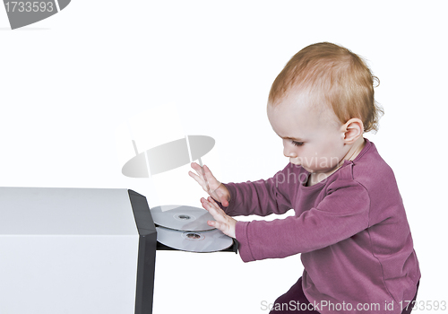 Image of young child playing with CD