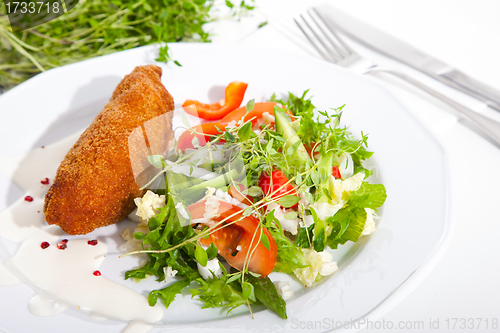 Image of garlic chicken kiev with mixed leaf salad