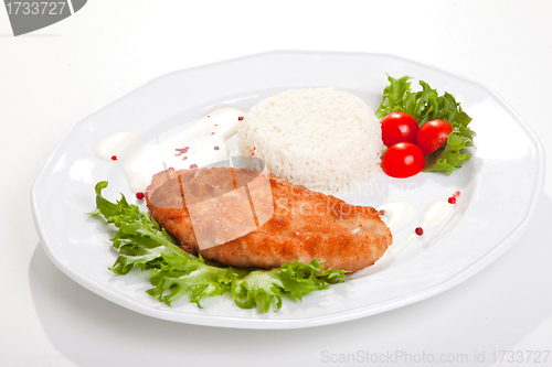 Image of  meat with mixed leaf salad an rice on white