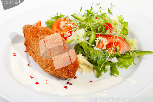 Image of garlic chicken kiev with mixed leaf salad