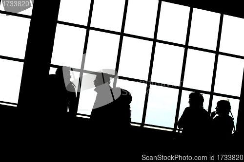 Image of people silhouettes on a big window