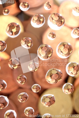 Image of euro coins in water drops