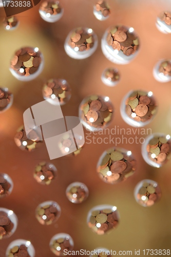 Image of euro coins in water drops