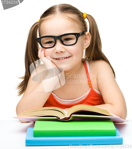 Image of Cute little girl with books