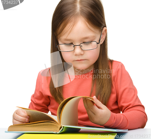 Image of Cute little girl reading book