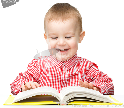 Image of Little child play with book