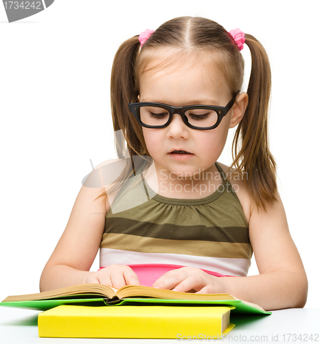 Image of Cute little girl reading book