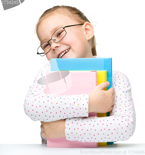 Image of Cute little girl with books