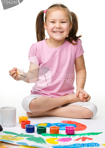 Image of Cute cheerful child play with paints