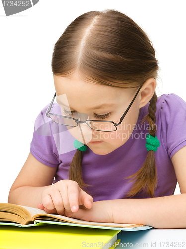 Image of Cute little girl reading book