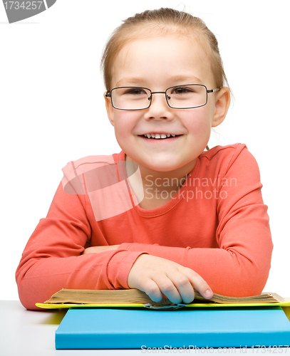 Image of Cute little girl reading book