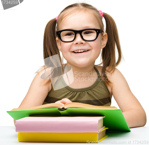 Image of Cute little girl reading book