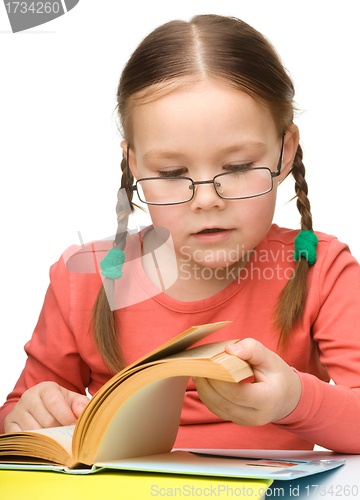 Image of Cute little girl reading book