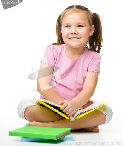Image of Cute little girl with book