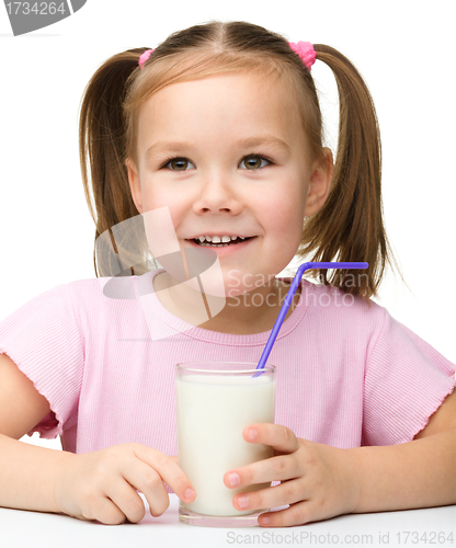 Image of Cute little girl with a glass of milk