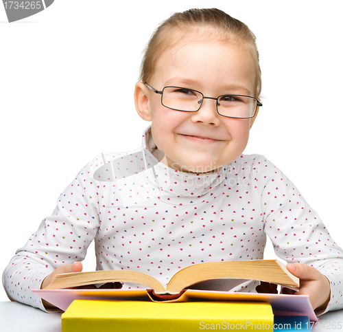 Image of Cute little girl reading book