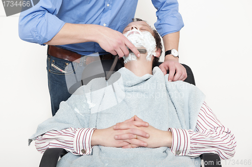 Image of Man Being Shaved With Cut Throat Razor