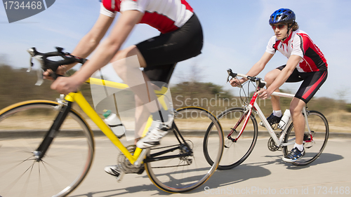 Image of Cyclists Riding On Country road