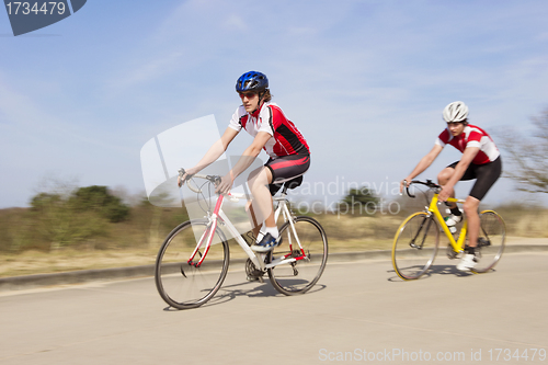 Image of Bicyclists Riding On An Open Country Road