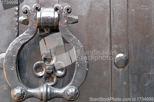 Image of Vintage metal door handle. Ancient architecture 