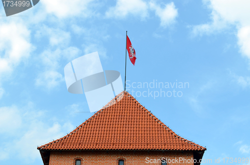 Image of Trakai castle tower and flag flying on top 