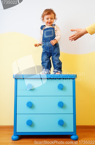 Image of Kid jumping from the cabinet